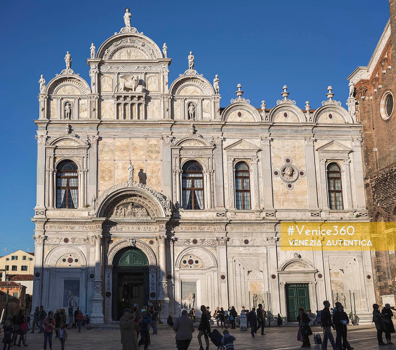 The Scuola Grande di San Marco in Venice, in the district of Castello. The facade shows classic renaissance and byzantine styles, ornamented with arches, niches, statues and light marbles.