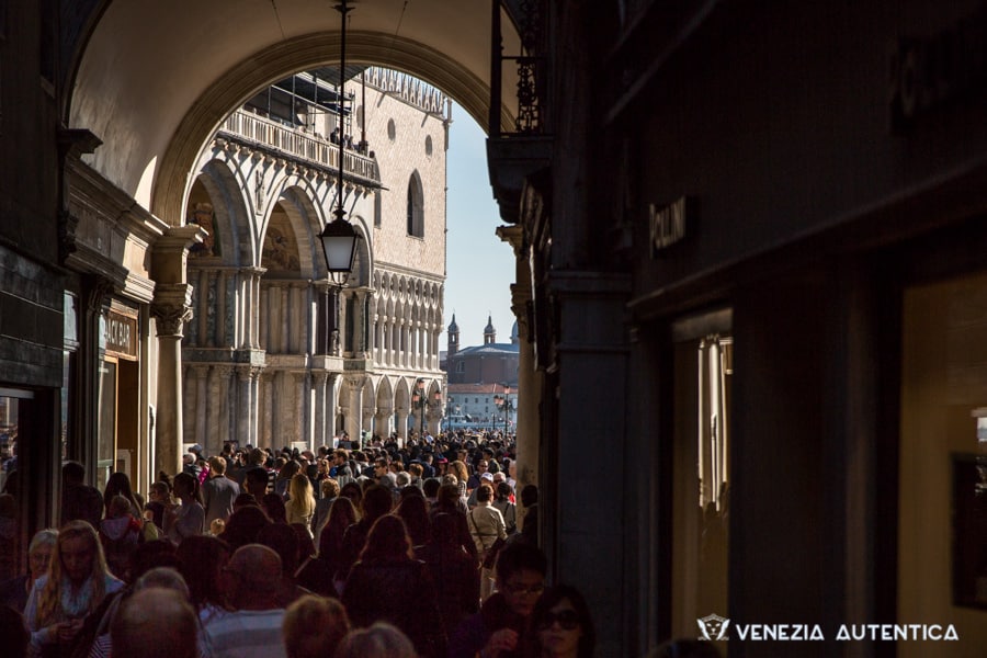 Mass tourism in Venice. Crowd of tourists going towards Saint Mark's square