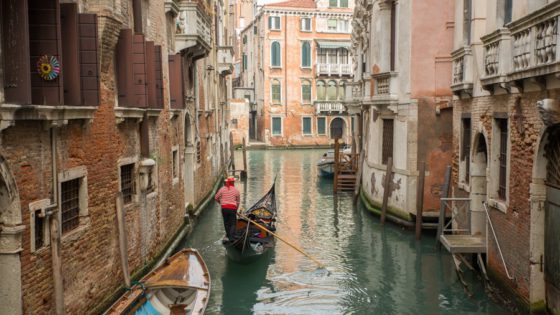 Gondolier rowing a gondola in Venice, Italy